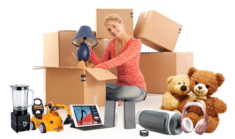 Young woman unpacking cardboard boxes